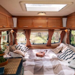 Large bed with pillows in the center of spacious travel house